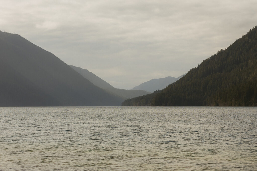 The mountains on the horizon over Lake Sutherland are shown from the shore of a PNW elopement