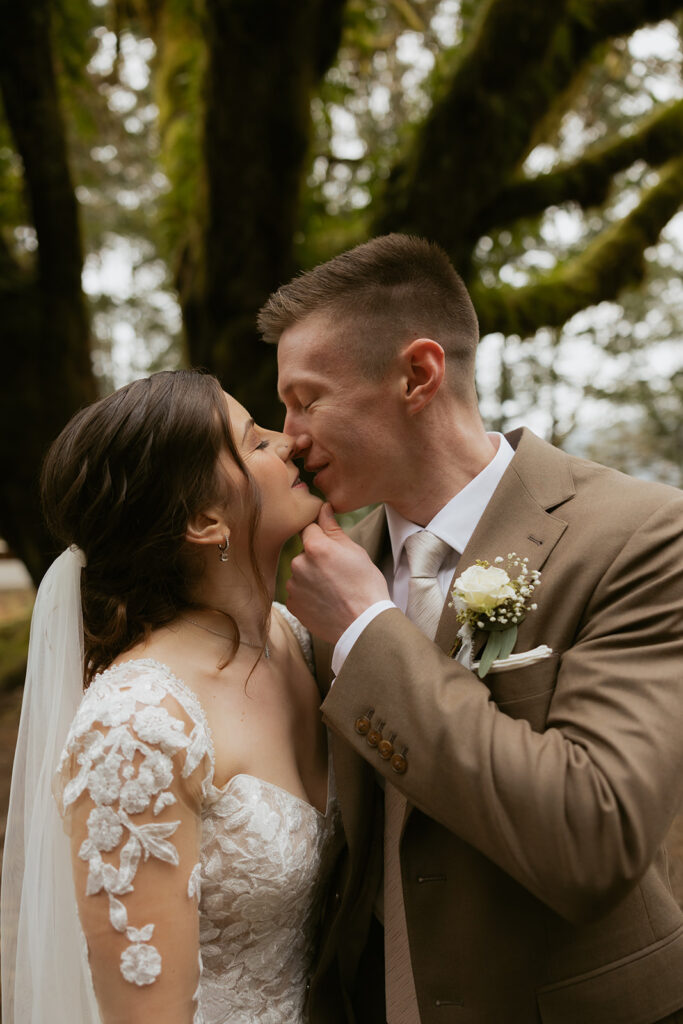 Newlyweds share a kiss following their intimate Lake Crescent wedding