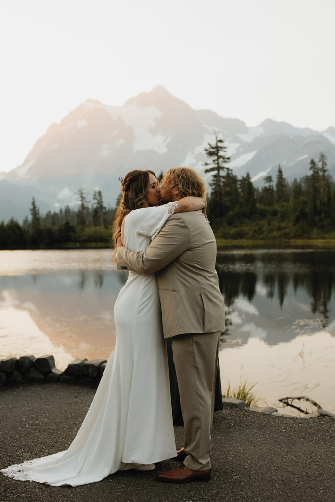 Newlyweds share a kiss in their wedding attire following their Mt. Baker elopement