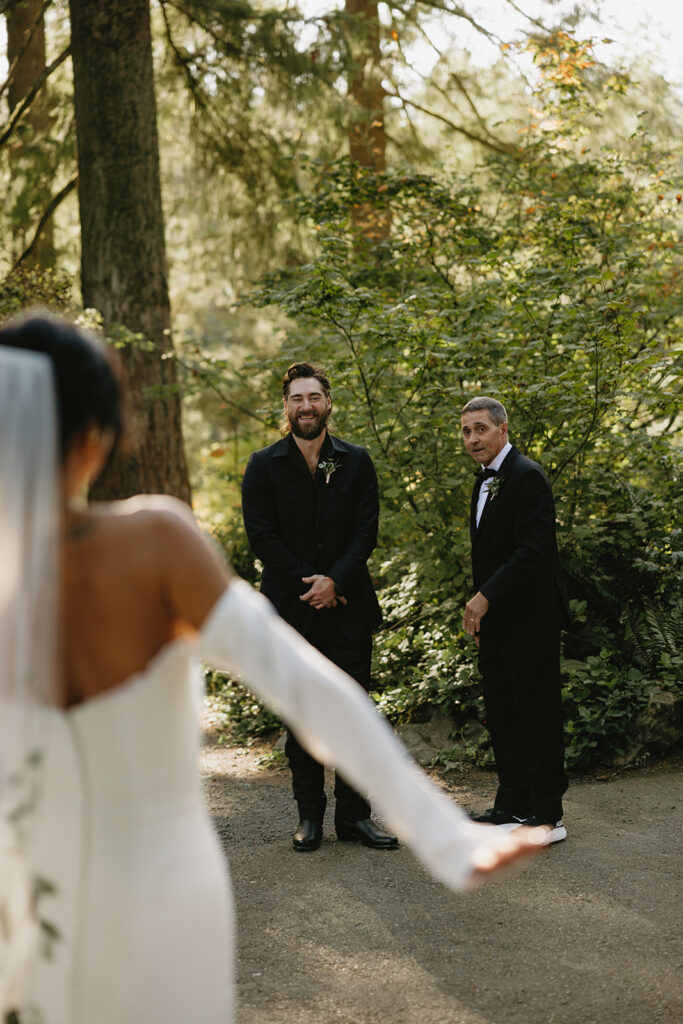 A bride does a first look with her family before her outdoor wedding in Portland Oregon