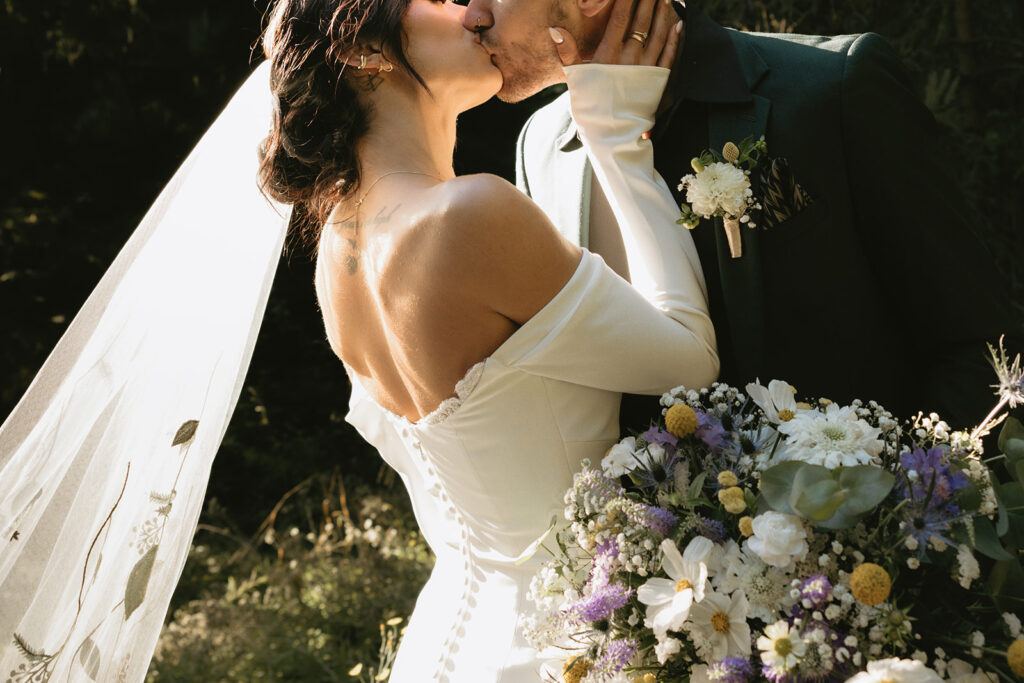 Newlyweds share a kiss at their Hoyt Arboretum wedding 