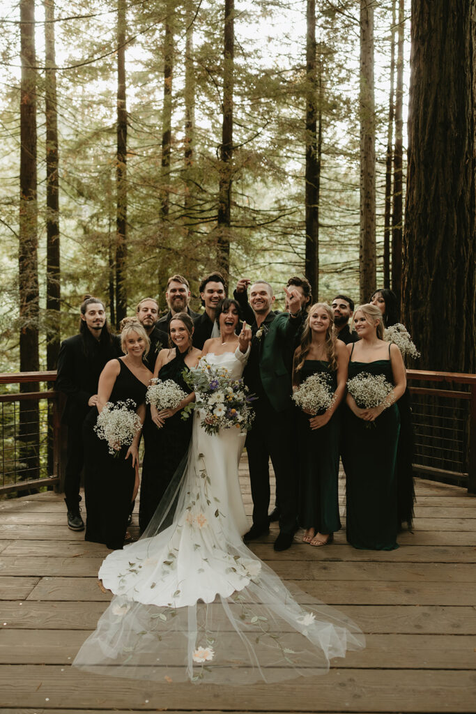 A bridal party poses for a photo on the Redwood Deck at a Hoyt Arboretum Portland wedding 
