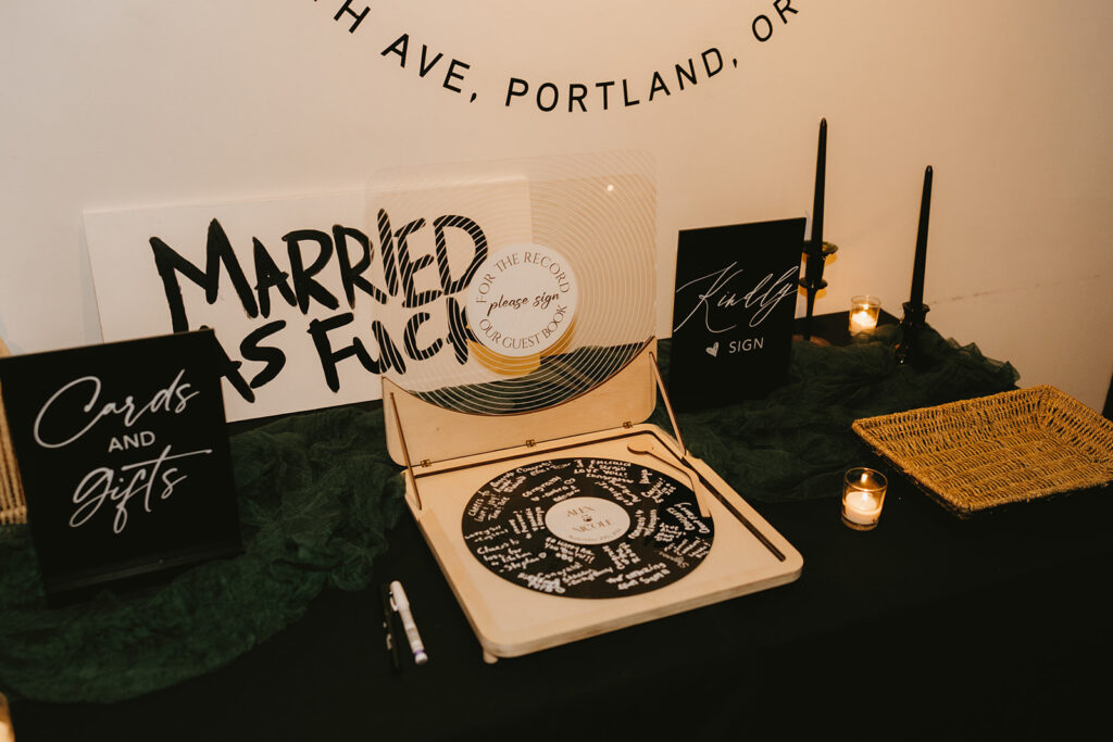A cards and gifts table with a vinyl record guest book is shown at a Coopers Hall wedding reception in Portland Oregon 