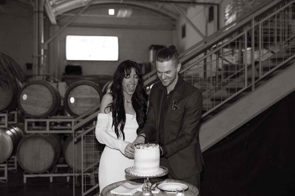 A bride and groom cut their wedding cake at their Coopers Hall wedding reception in Portland OR