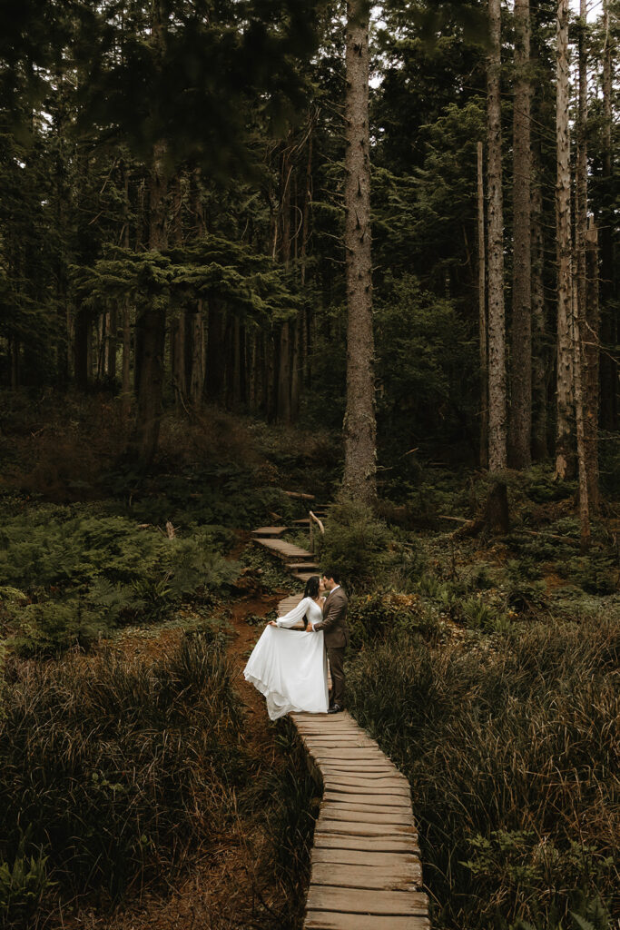 Newlyweds exchange a kiss in a bridal portrait taken after their national park elopement at Cape Flattery