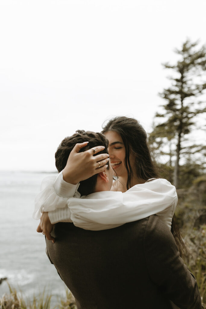 An Olympic National Park wedding day photo depicts a bride & groom at Cape Flattery following their ceremony