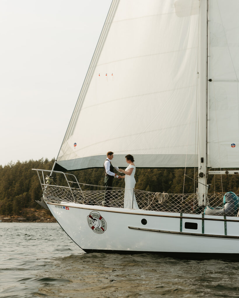 Newlyweds are photographed aboard a sail boat in Friday Harbor after eloping in Washington state
