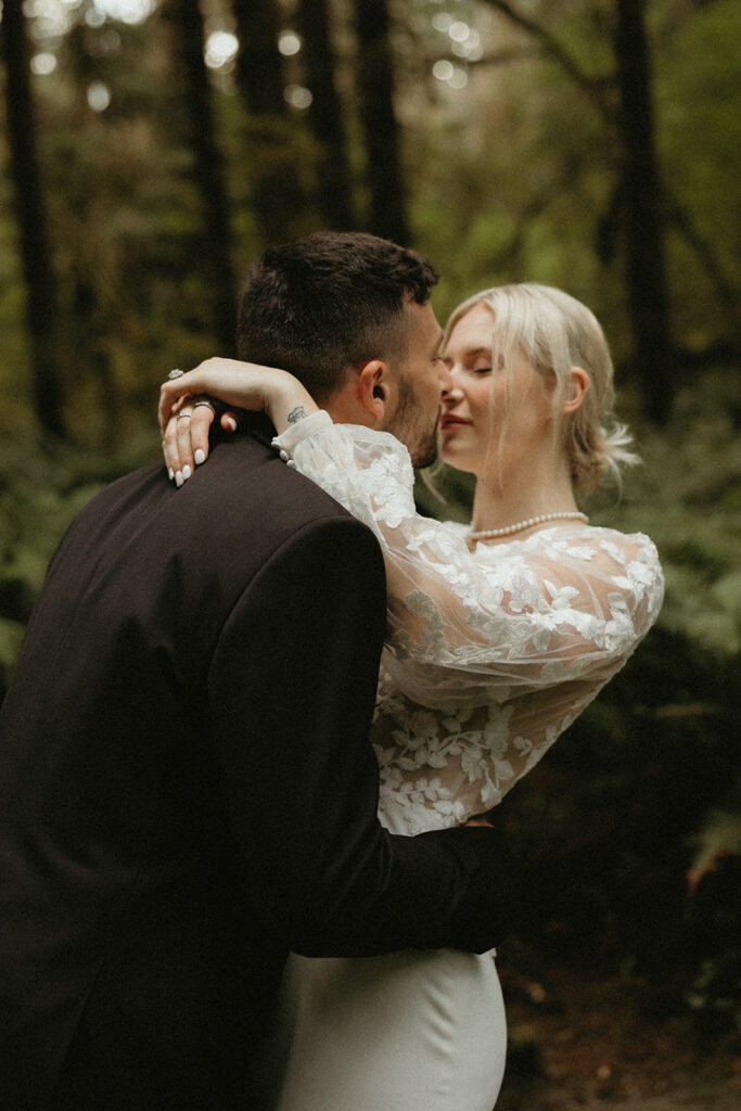 A bride and groom share a kiss after eloping in Washington state