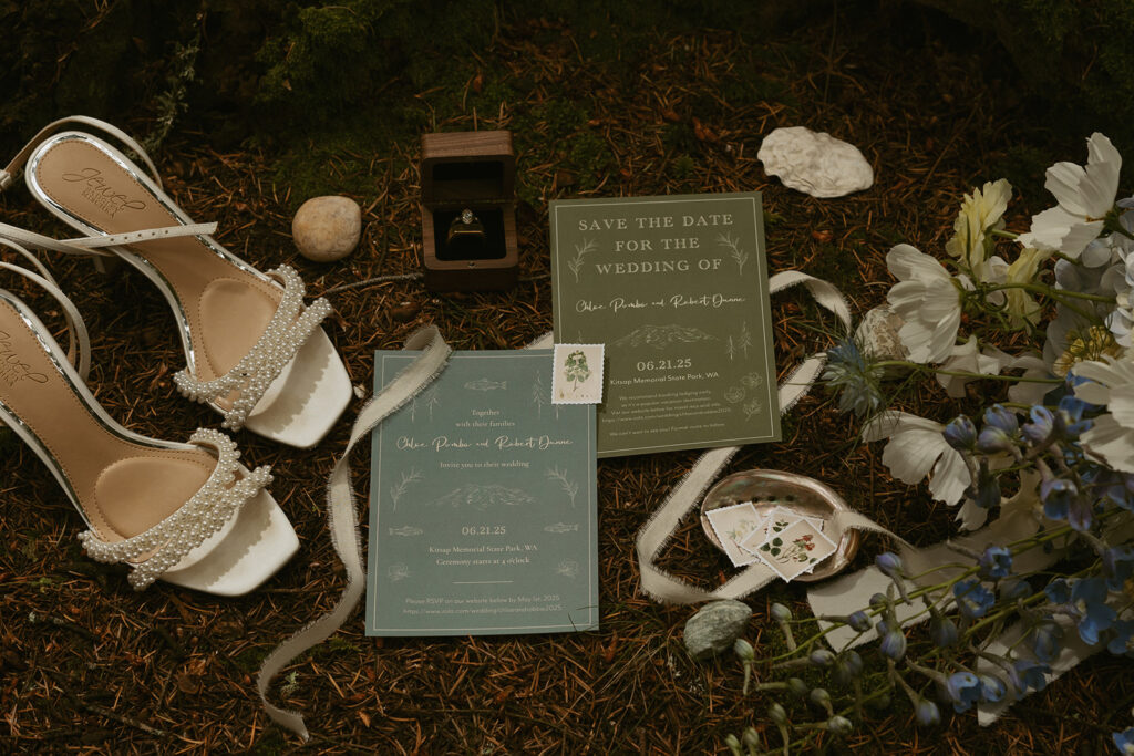 Wedding details in green & teal are photographed on the forest floor at a Washington state elopement