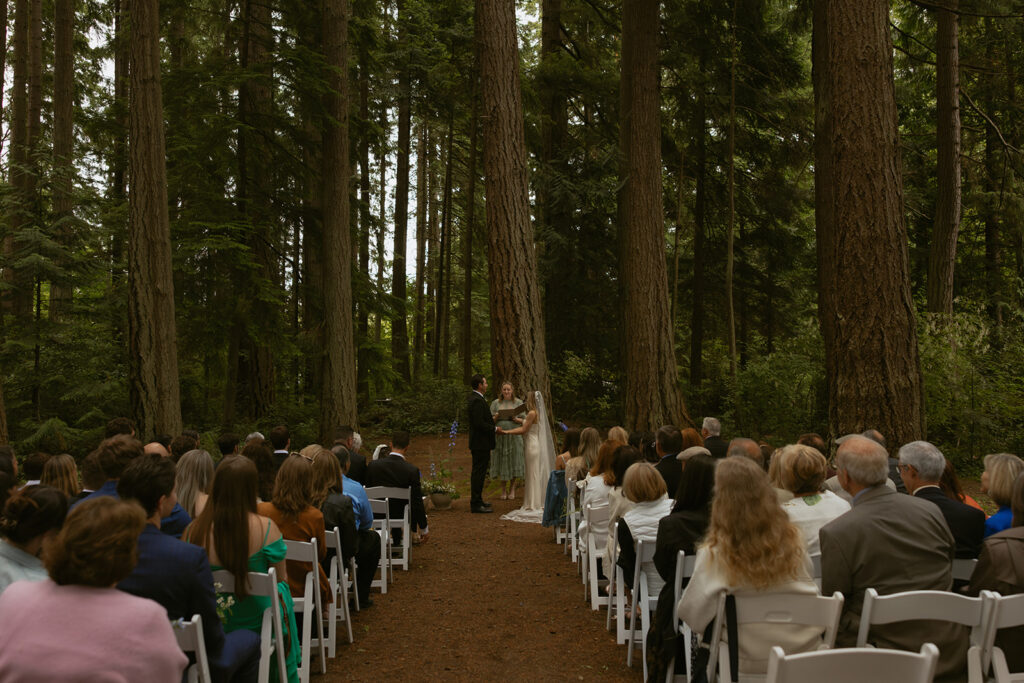 A bride and groom exchange vows at their Kitsap Memorial Park wedding ceremony