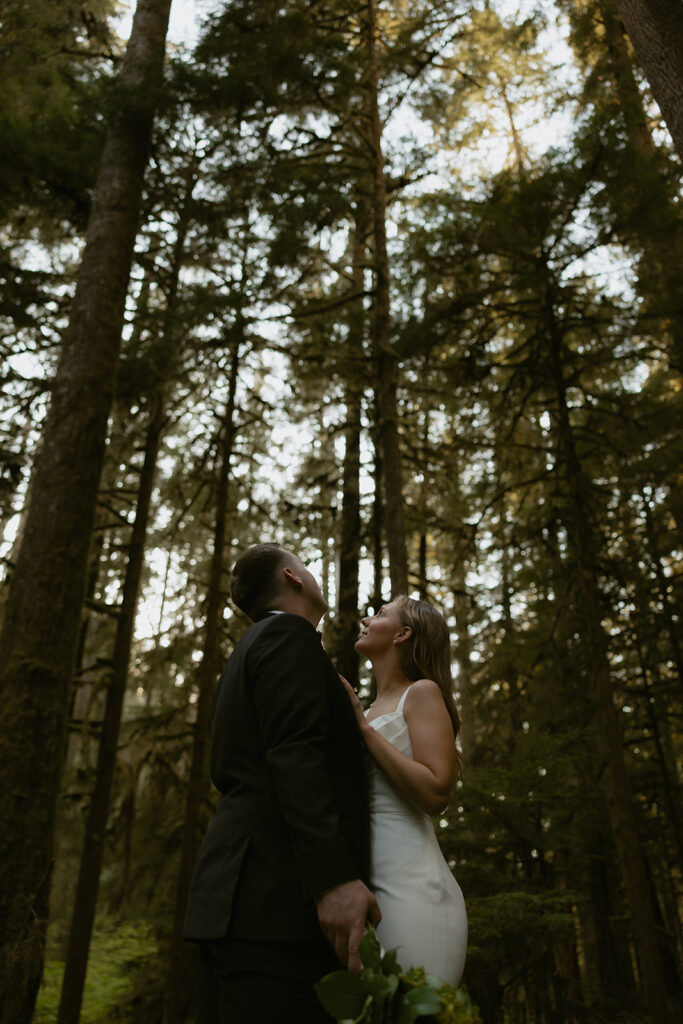 Newlyweds are photographed among the pines at their Lake Crescent elopement.