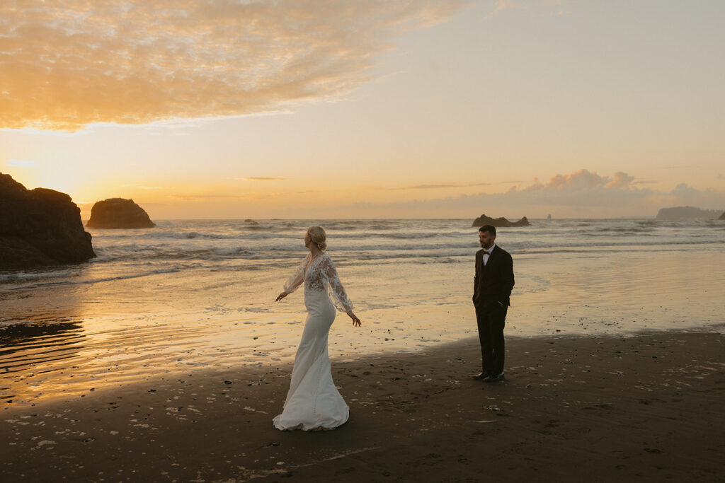 Newlyweds are photographed at the waters edge at sunset following their Ruby Beach elopement.