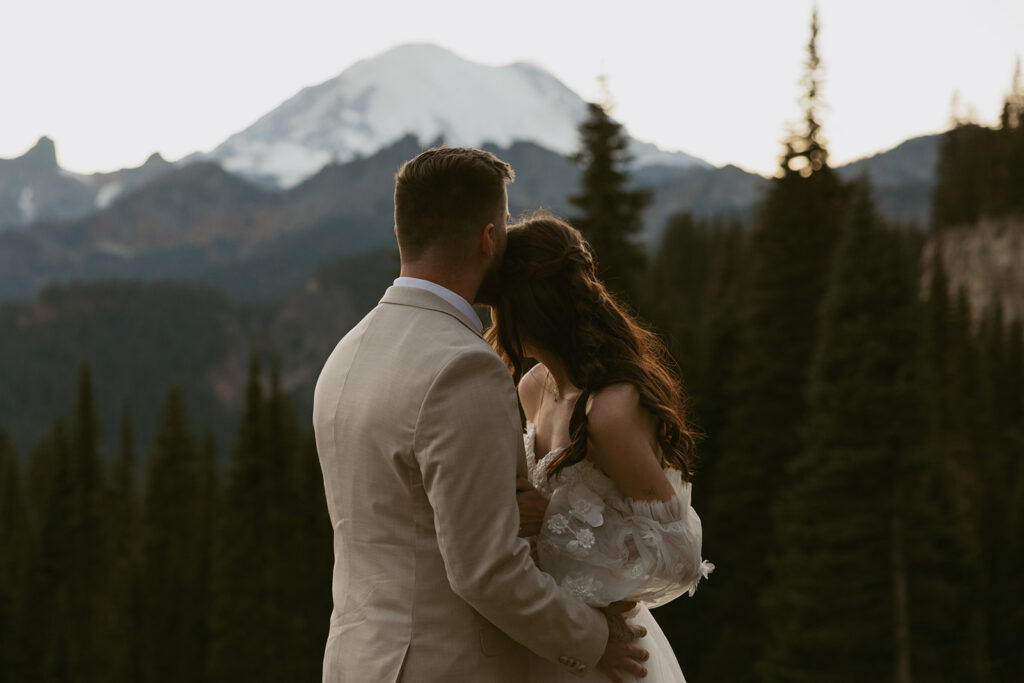 Newlyweds embrace as they look out over Tipsoo Lake, one of highly recommended Washington elopement locations.