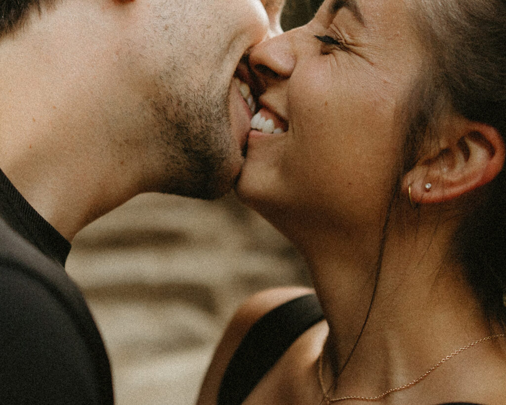 A close up image of a couple smiling against each other during Washington engagement photos 