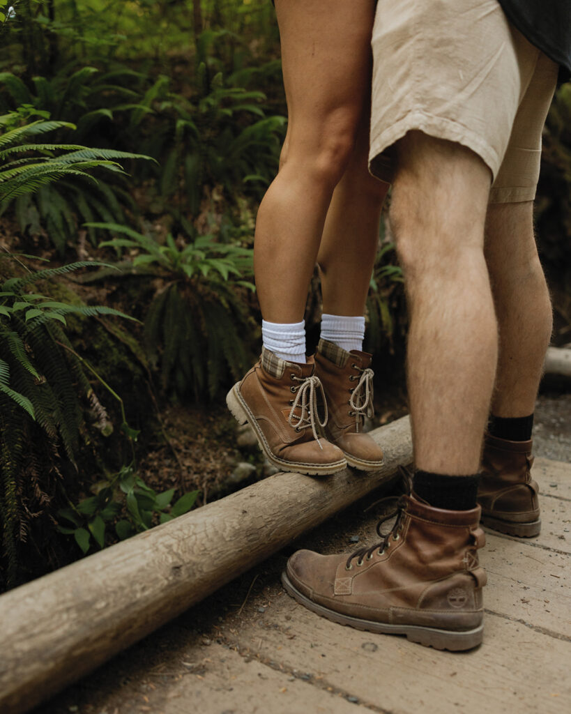 A couple wearing hiking boots is photographed during Washington engagement photos taken at Franklin Falls