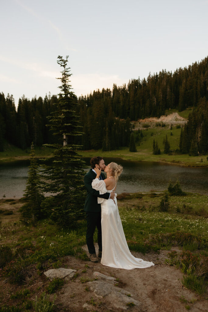 A bride & groom share a kiss next to Tipsoo Lake, one of many breathtaking mt rainier wedding locations