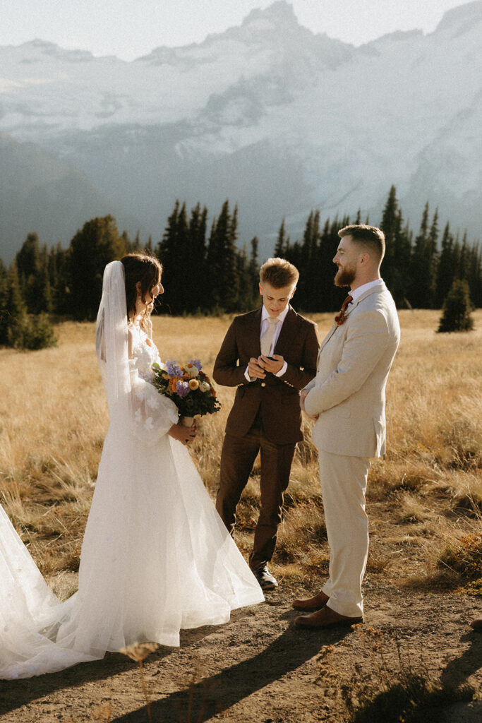 A couple exchanges vows at their mount rainier wedding