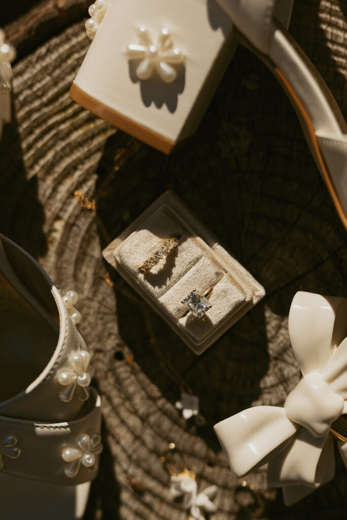 Wedding rings and jewelry are shown in a flat lay detail shot from a mt rainier elopement