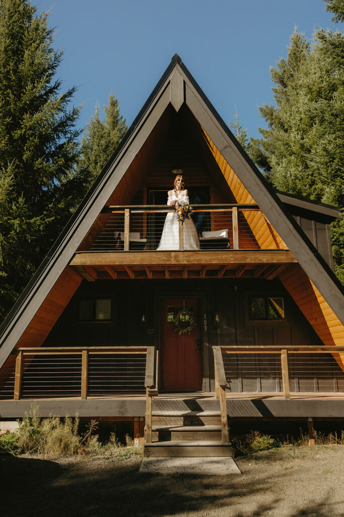 A bride is photographed in her gown on the top floor of a mount rainier a frame