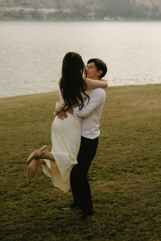An engaged couple embrace during a romantic moment at their willow point park engagement session