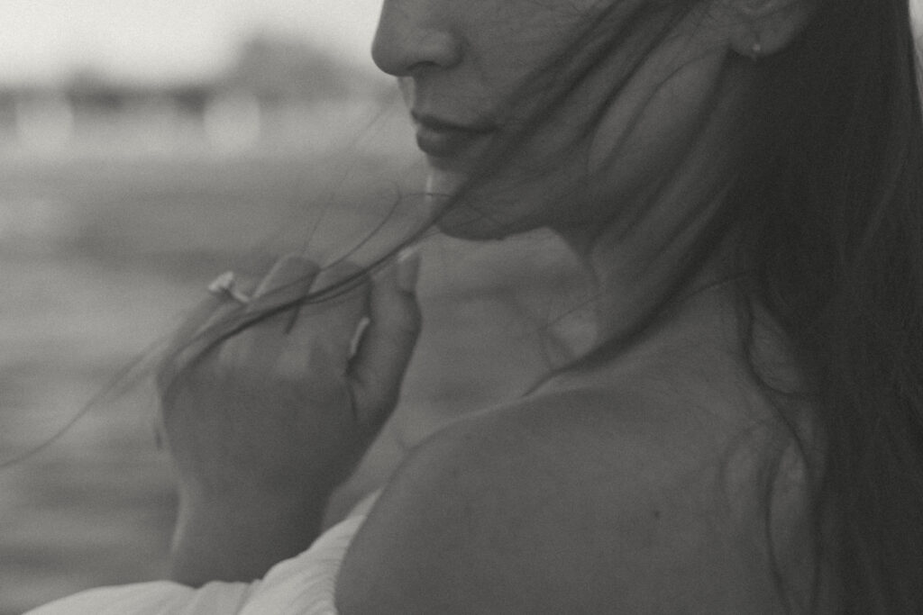 Wind blowing through a woman’s hair during her sail boat engagement session in Seattle