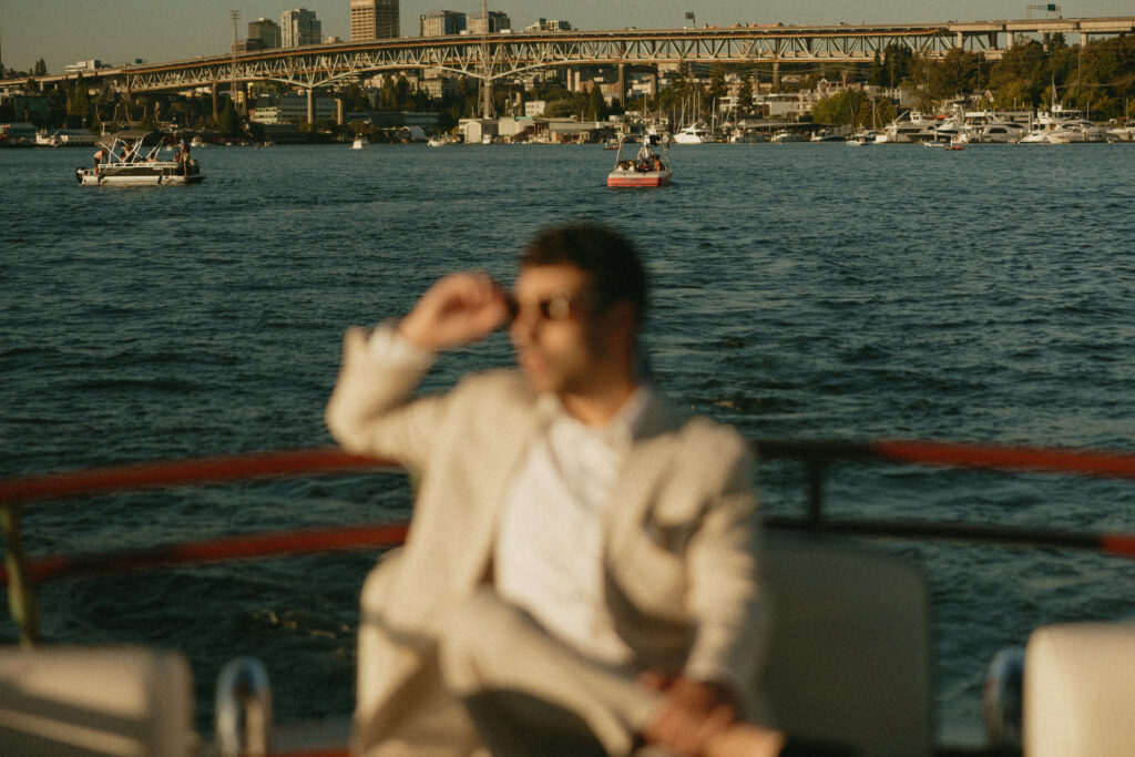 An out of focus man touching his sun glasses