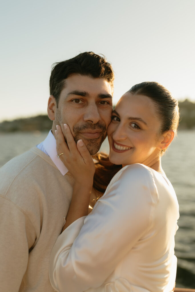 A couple smiling together during their engagement session on Lake Union