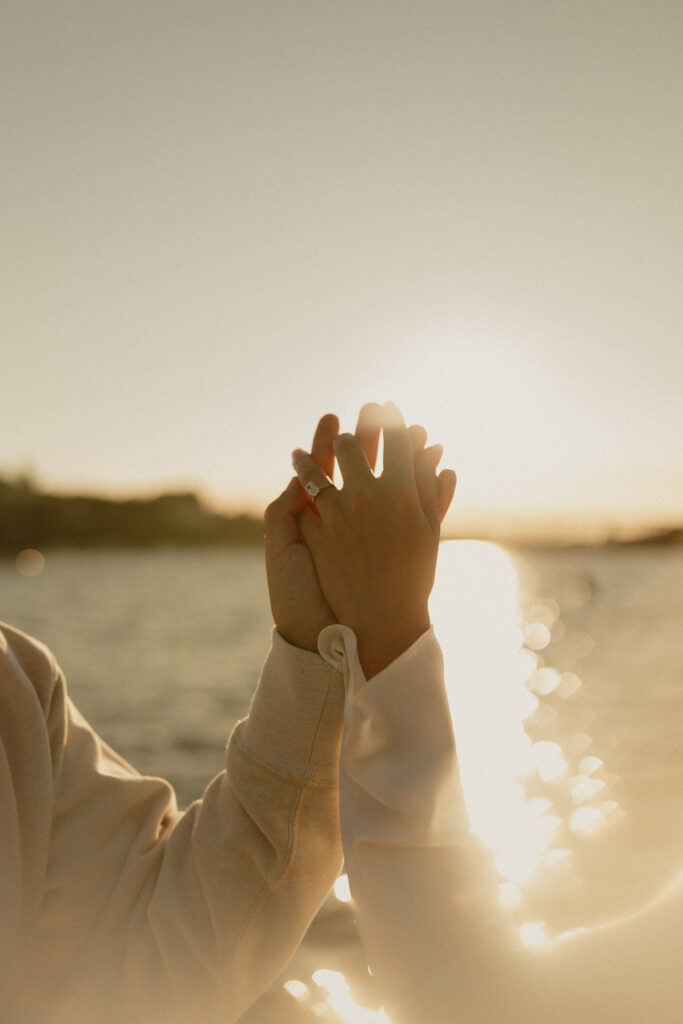 A couple holding hands in the golden sunset light