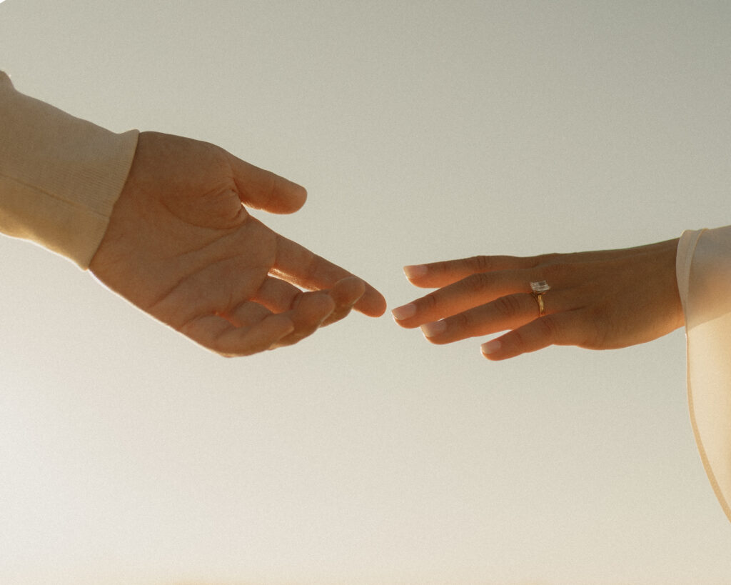 A couple reaching out for each other