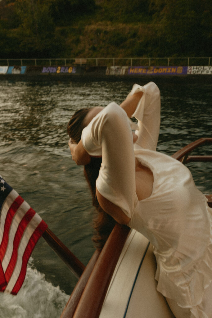 A woman leaning over the back of a back on Lake Washington