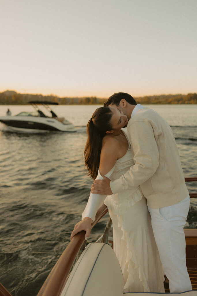 A man kissing a womans neck while on a boat