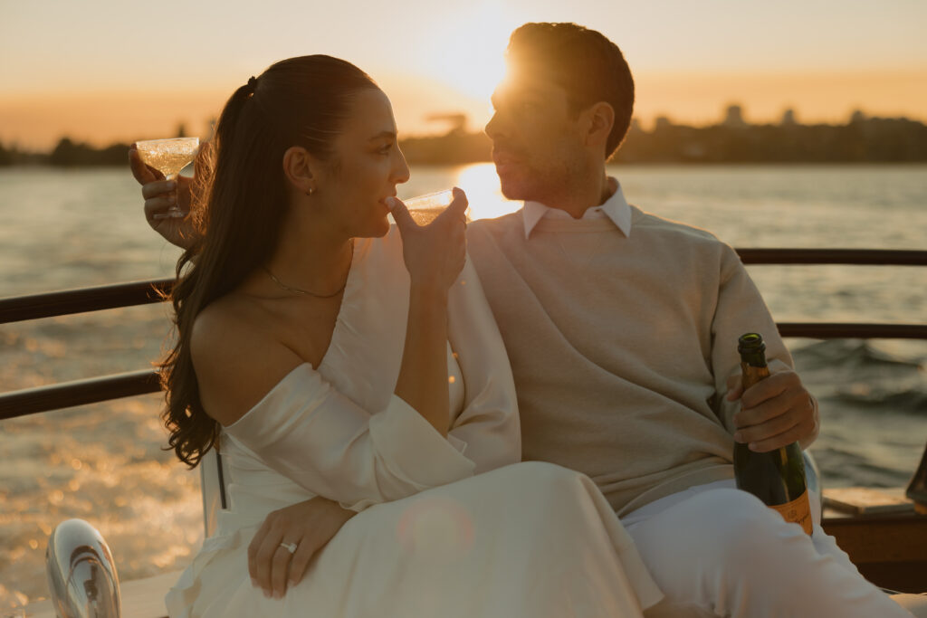 A man and woman drinking champagne together while on a boat