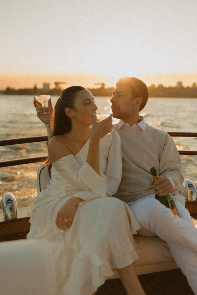 A man and woman drinking champagne together while on a boat