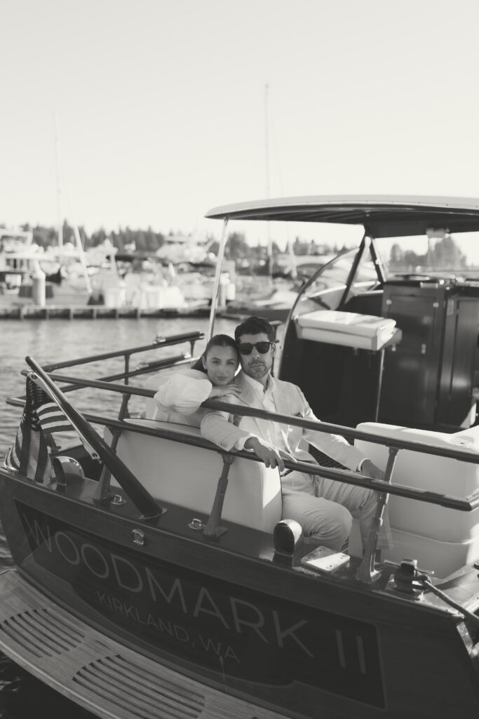 A couple sitting together in the back of a boat