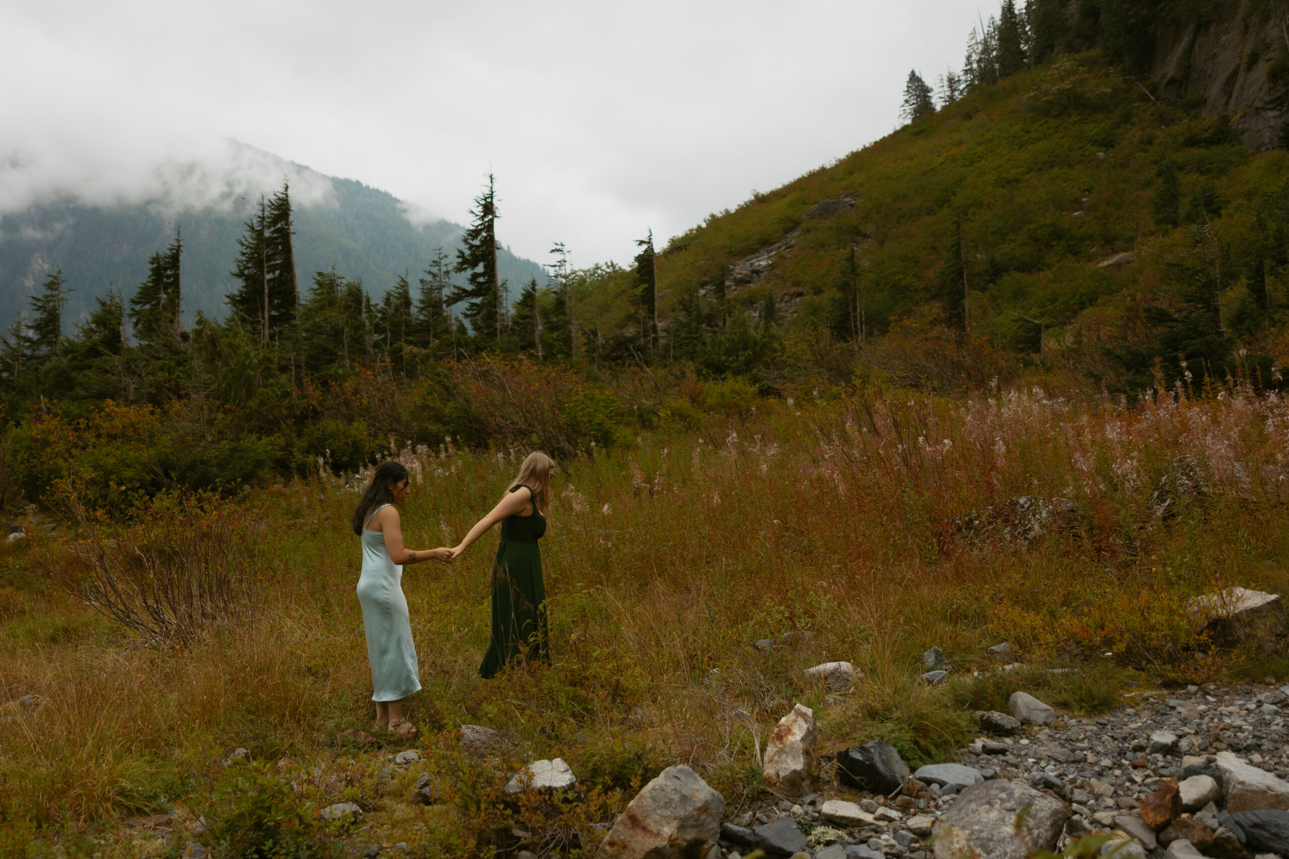 Couple walking together through the mountains during their Granite Falls, Washington engagement session with elopement photographer Tessa Marie Collective